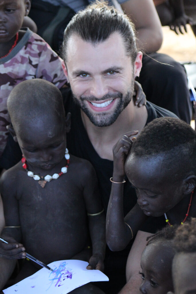 Man with children painting